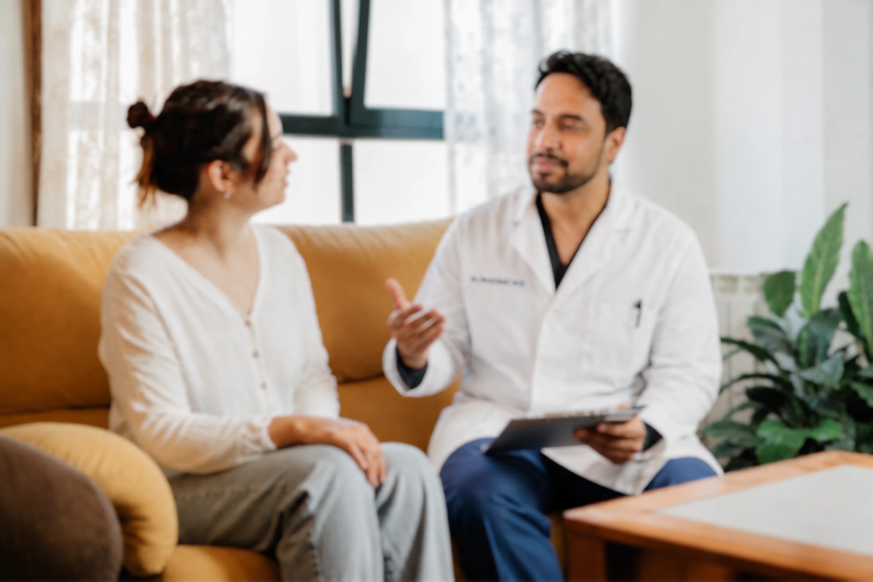 A physician speaking with a patient during a visit
